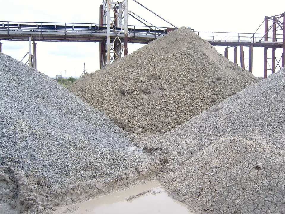 Stockpiles of bentonite clay at a mineral processing plant